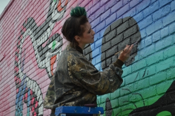 Local artist Shaina Kasztelan donning green hair to match her mural. (ISO 200, 55mm, f5.6, 1/640)